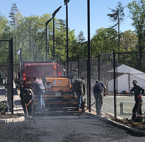 a macchione brothers employees paving a road