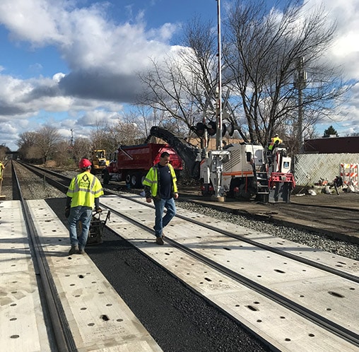 a macchione brothers employees working on railroad asphalt