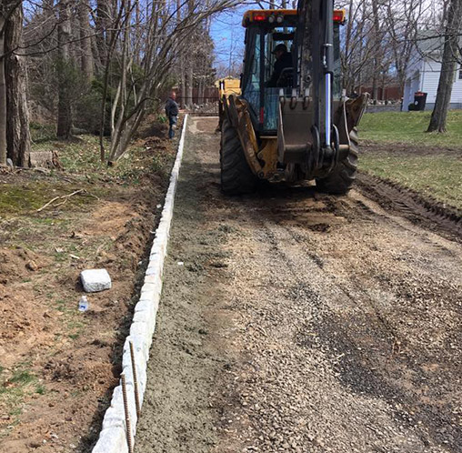 excavator working on driveway