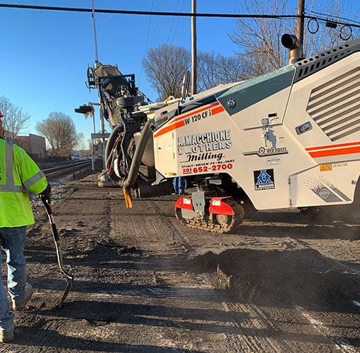 a macchione brothers employees milling a road