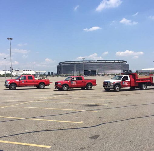 three red trucks in parking lot